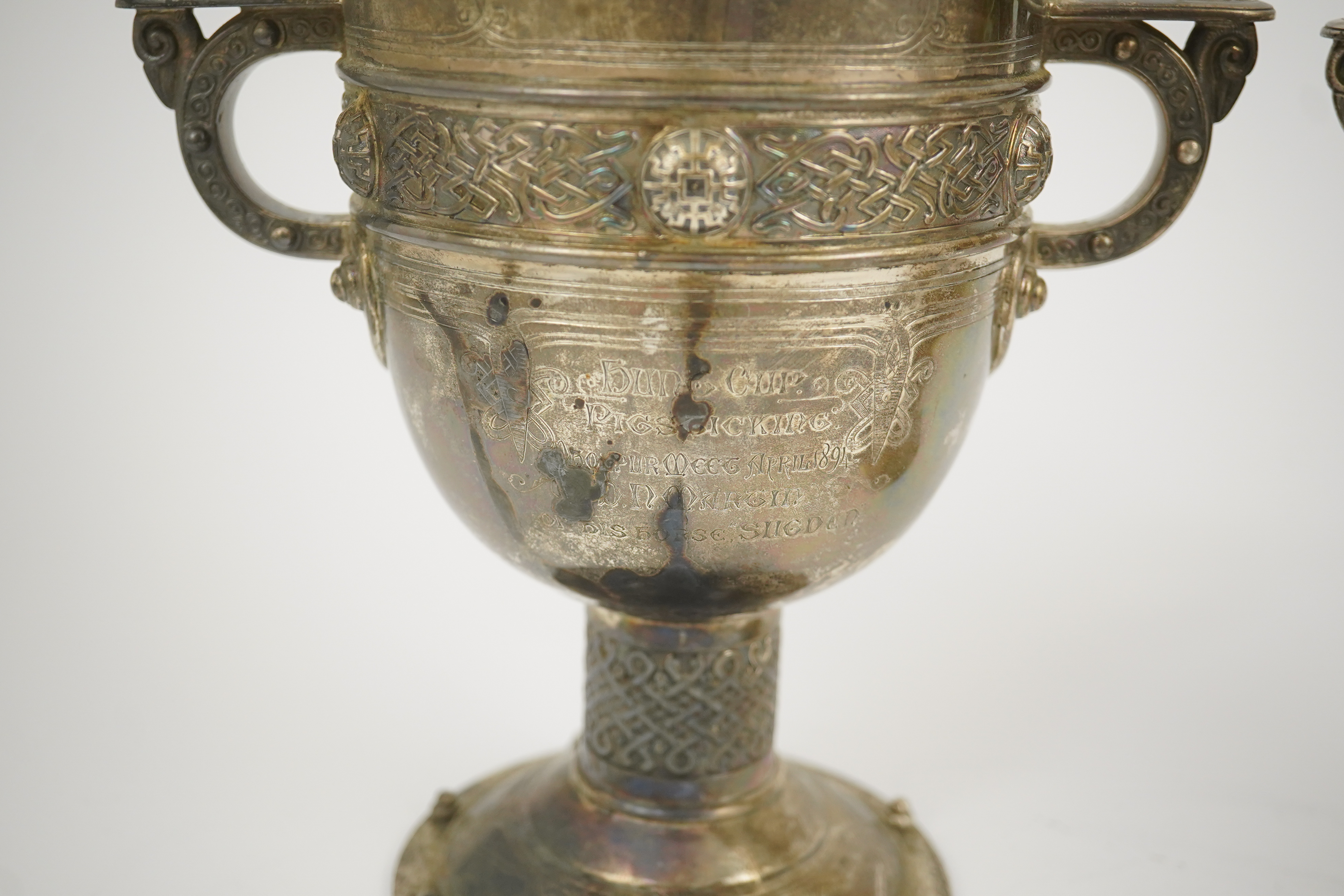 A pair of late Victorian Arts & Crafts Celtic style silver two handled presentation pedestal trophy cups, by Elkington & Co